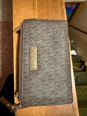 Michael kors brown and tan wallet with tag still inside.